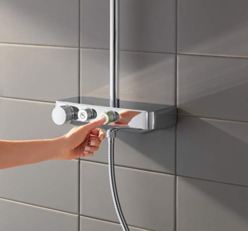 Chrome thermostatic shower system with handheld showerhead, control valve, and hose mounted on tiled bathroom wall.