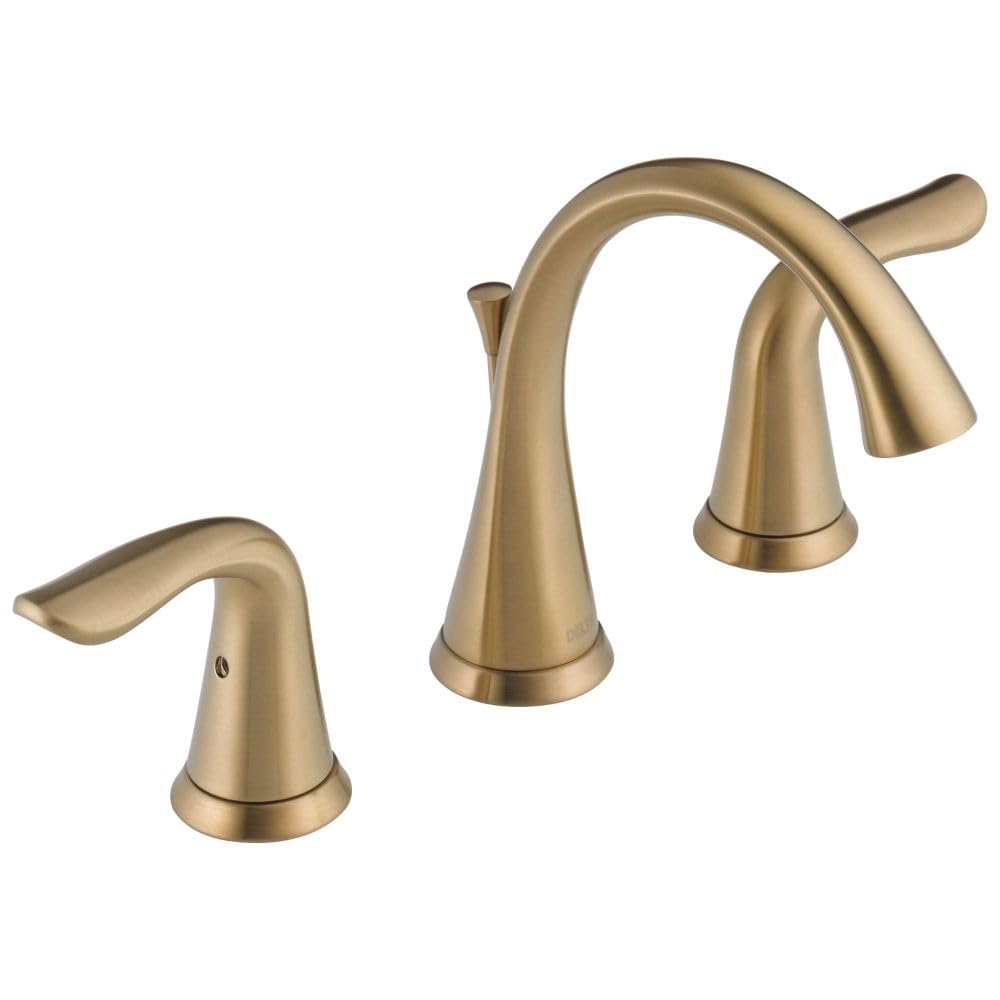 Champagne bronze widespread bathroom faucet with curved spout and two lever handles.