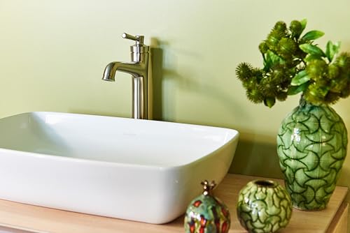 Brushed nickel single-hole faucet with tall spout installed above white rectangular vessel sink.