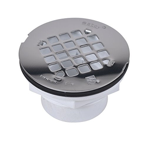 Round PVC shower drain with gray strainer top featuring square perforations and white threaded base.