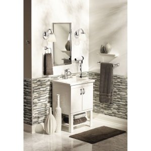 Brushed nickel wall-mounted towel ring installed above bathroom sink with towels draped over the ring.