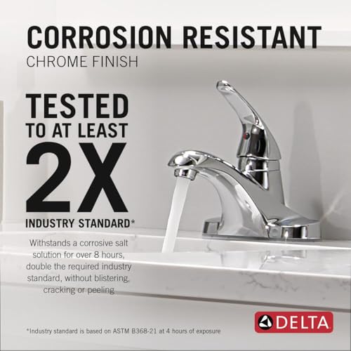 Chrome single-handle centerset bathroom faucet with curved spout and lever handle installed on white sink.