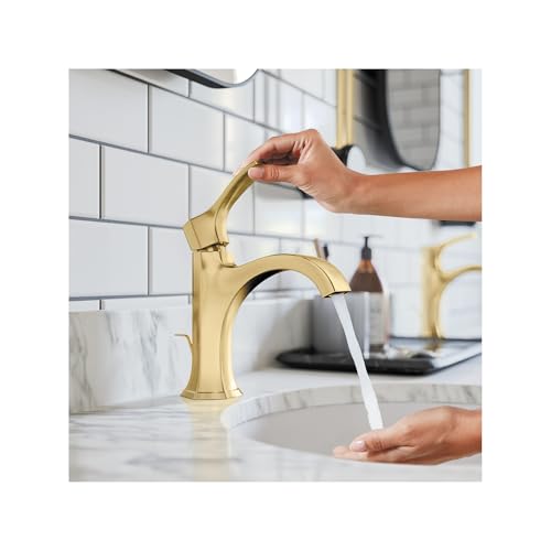 Brushed gold single-hole bathroom faucet with tall curved spout and pop-up drain, shown installed on marble countertop with w