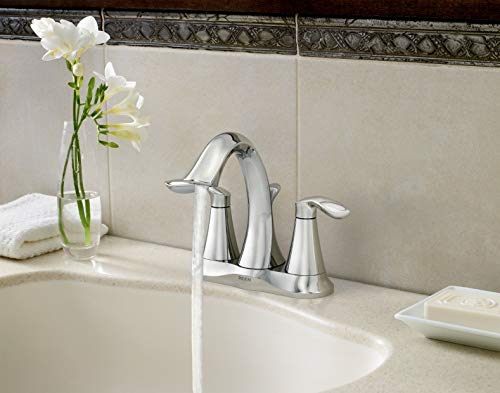 Chrome double handle bathroom faucet with high arc spout installed on white sink countertop.