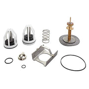 Watts RPZ repair kit containing white cartridge caps, internal springs, metal bracket, brass valve stem, rubber seals, and wa