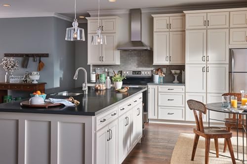 Spot Resist Stainless steel pull-down kitchen faucet with side handle mounted on white cabinetry island.