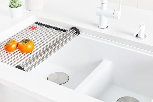 Stone grey single bowl undermount sink with drain hole and matching drying rack in white countertop.