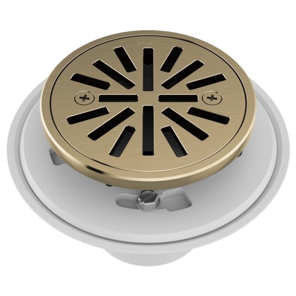 Round shower drain with luxe gold cover and radial slot pattern, mounted on white base ring.