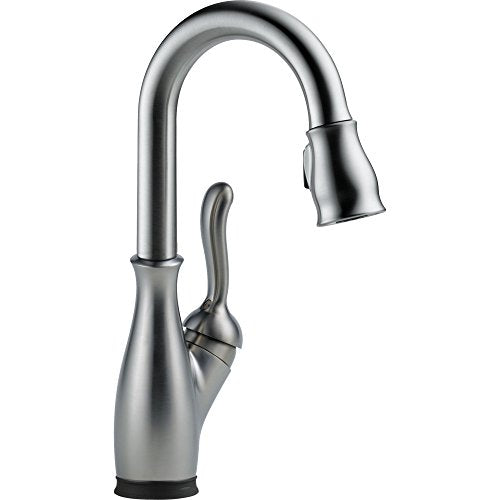 Chrome single-handle kitchen faucet with curved spout and pull-down spray head.