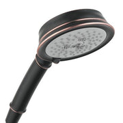 Rubbed bronze handshower with round white face plate and multiple jet holes, attached to dark handle with copper accents.