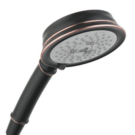 Rubbed bronze handshower with round white face plate and multiple jet holes, attached to dark handle with copper accents.