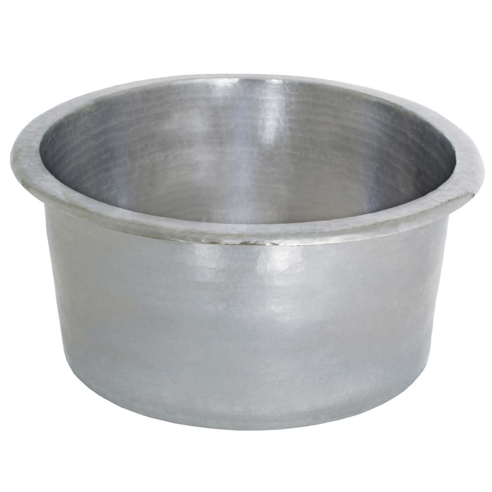 Hammered copper cylindrical bar sink with rolled rim and sloped interior basin.
