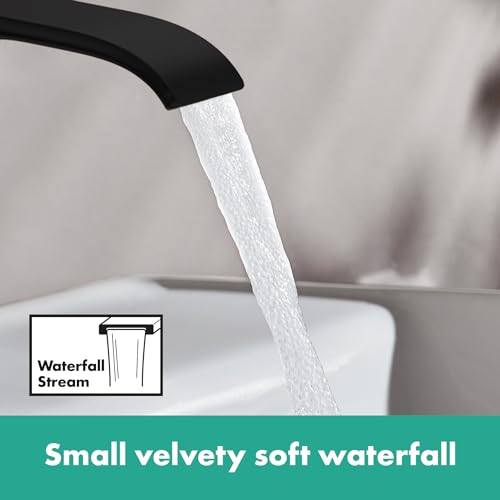 Matte black single-hole faucet with curved spout dispensing water in a soft waterfall stream.