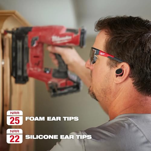 Man wearing red and black earbuds with foam and silicone ear tip options while operating red power tool.