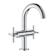 Chrome two-handle bathroom faucet with curved spout and cylindrical handles on circular base.