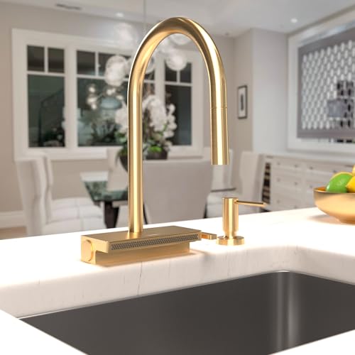 Brushed gold high arc kitchen faucet with pull-down spray head mounted on white countertop above dark sink.