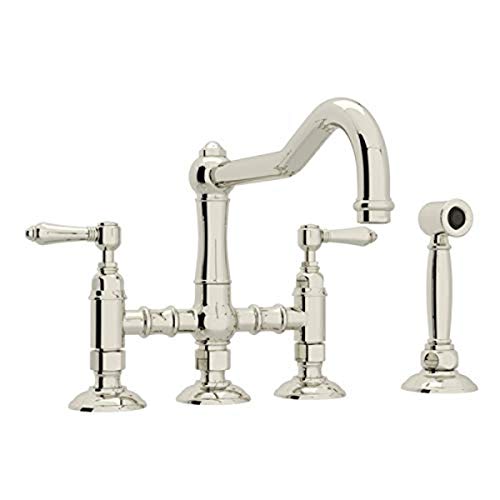 Polished nickel bridge kitchen faucet with arched spout, two handles, and matching side spray attachment.