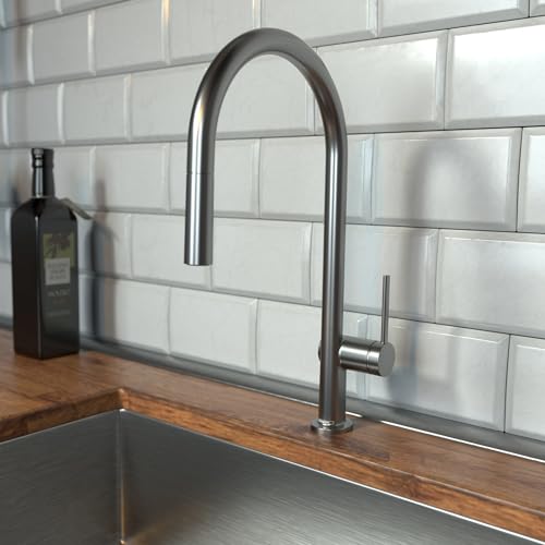 Brushed black chrome kitchen faucet with high arched spout and pull-down spray head mounted on wooden countertop.