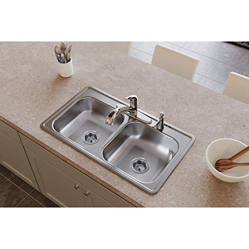 Stainless steel drop-in sink with two equal rectangular bowls and two faucet holes mounted in countertop.