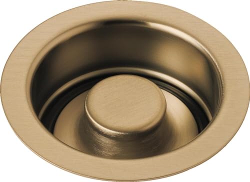Champagne bronze sink flange with matching cylindrical stopper plug installed in center.