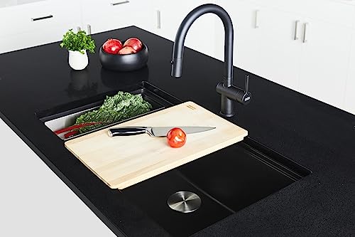 Black pull-down kitchen faucet with curved spout installed above black countertop sink with cutting board and vegetables.