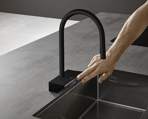 Matte black high-arc kitchen faucet with pull-down sprayer head being pulled toward sink basin.