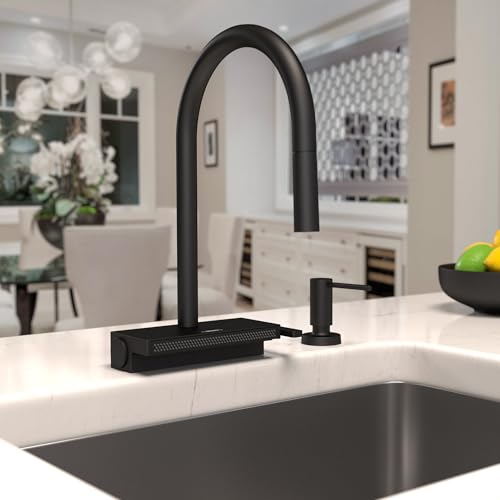 Matte black high-arc kitchen faucet with pull-down spray head and matching soap dispenser mounted on white countertop.