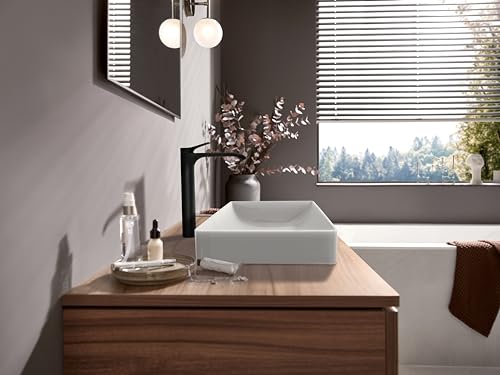 Matte black single-hole bathroom faucet with curved spout installed above white vessel sink on wooden vanity.