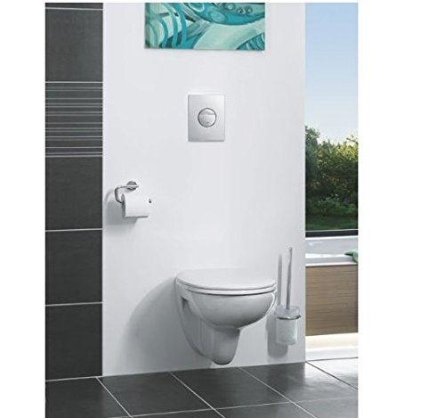 Chrome paper holder mounted on white bathroom wall next to wall-mounted toilet.