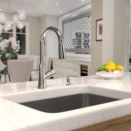 Chrome high-arc kitchen faucet with pull-down spray nozzle installed in white undermount sink.