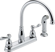 Chrome two-handle kitchen faucet with arched spout and lever handles on white base.