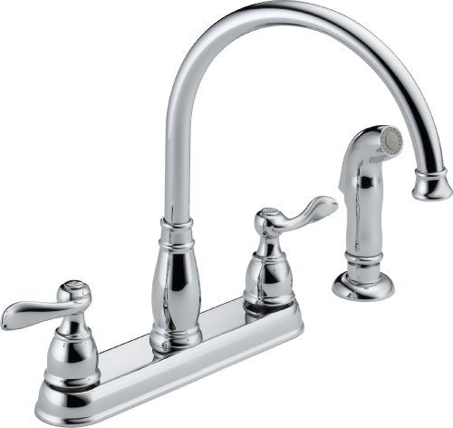 Chrome two-handle kitchen faucet with arched spout and lever handles on white base.