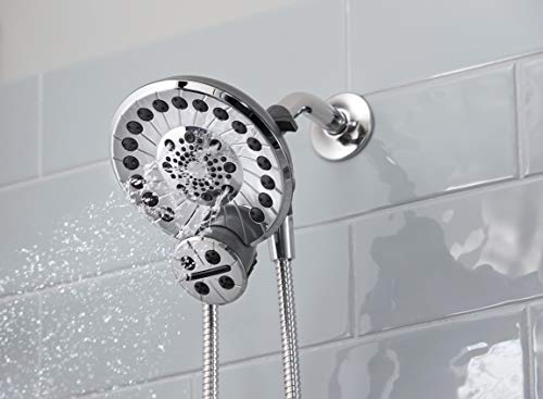 Chrome shower head with multiple spray holes mounted on wall with attached hose, water spraying downward.