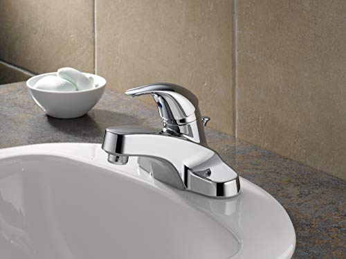 Chrome single-handle bathroom faucet with curved spout mounted on white sink countertop.