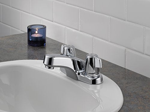 Chrome two-handle bathroom faucet with curved spout mounted on sink counter.
