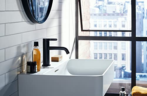Chrome single-hole bathroom faucet with angular handle mounted above white vessel sink.