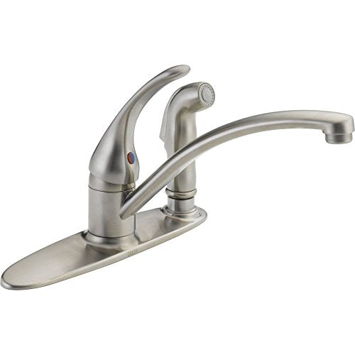 Brushed chrome single-handle kitchen faucet with curved spout and side spray attachment on oval base.