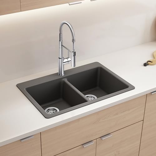 Cinder gray double basin drop-in sink with low divider and chrome pull-down kitchen faucet.