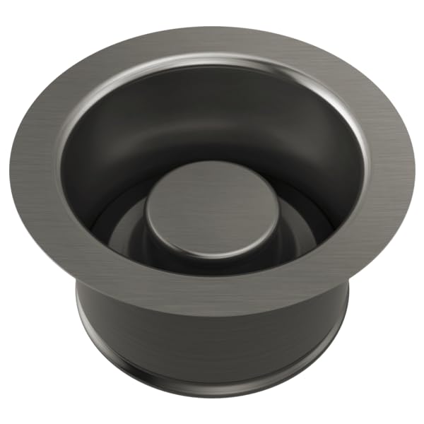 Gunmetal gray disposal flange with matching cylindrical stopper and brushed metal finish.
