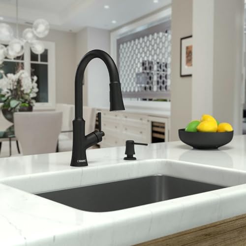 Matte black high-arc kitchen faucet with pull-down spray mounted on white countertop sink.