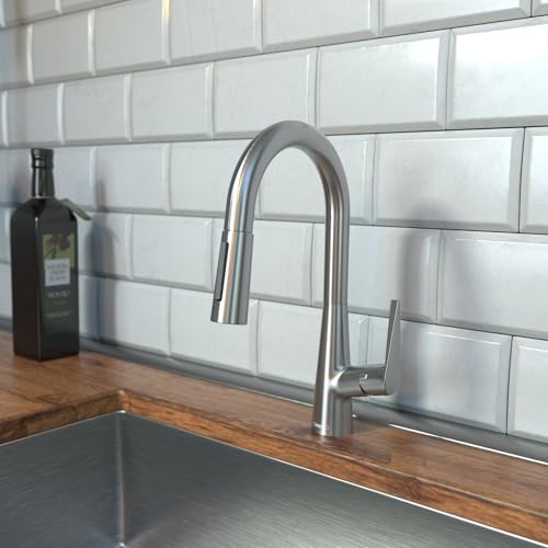Steel Optic pull-down kitchen faucet with curved spout installed above wooden countertop and white subway tile backsplash.