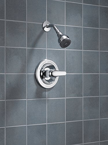 Chrome shower valve with single lever handle and matching showerhead on tiled wall.