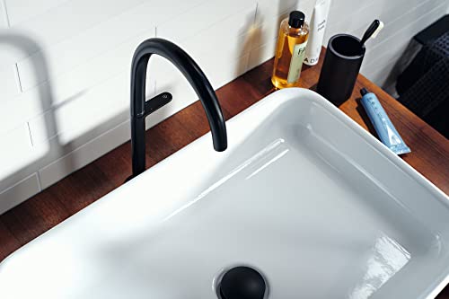 Matte black single-hole bathroom faucet with curved spout mounted above white rectangular sink.