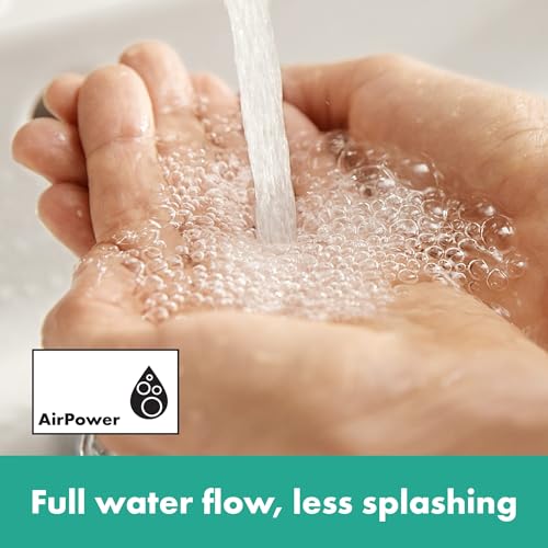 Water flowing from faucet onto cupped hands demonstrating full water stream with minimal splashing.