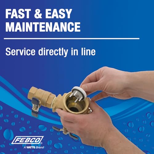 Bronze pressure vacuum breaker with 1-inch union connection being serviced by hand.