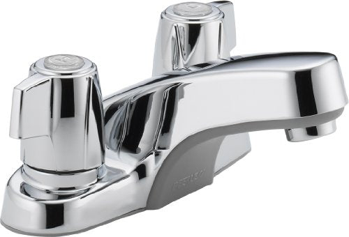 Chrome two-handle bathroom faucet with rounded spout and circular handles on wide base.