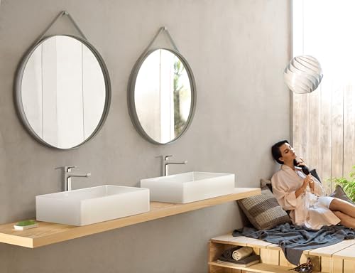 Brushed nickel single-hole bathroom faucet with tall spout mounted above white vessel sink.