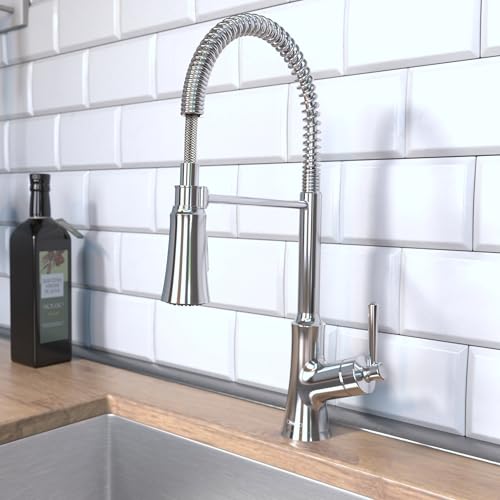 Chrome semi-pro kitchen faucet with coiled spray hose and single lever handle on white subway tile backsplash.