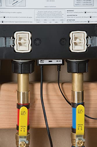 Moen S3104 digital valve with dual brass outlets, control module, and color-coded inlet connections on wooden backing.