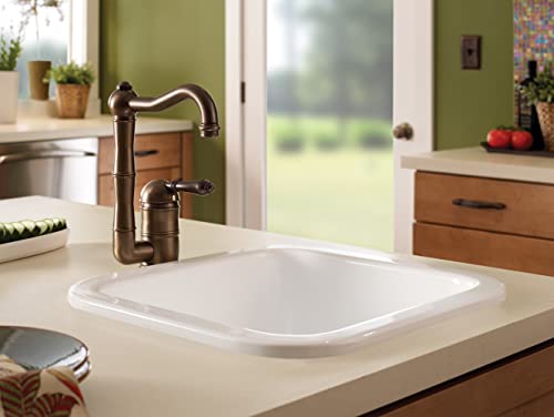 White rectangular fireclay bar sink with rounded corners and bronze faucet installed in beige countertop.